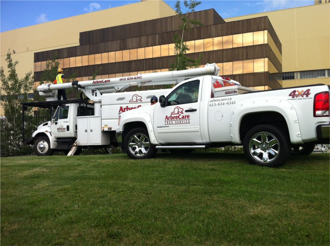 AbreCare branded bucket trucks lined up in front of commercial building