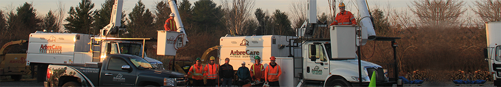 AbreCare team posing in and around work trucks